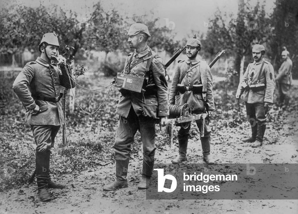 A German soldier passes information about observations and the localization of his battalion with a campaign phone between 1914-1918