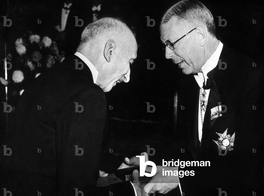 French writer Francois Mauriac receiving Nobel prize 1952 from king Gustav Adolf of Sweden in Stockholm