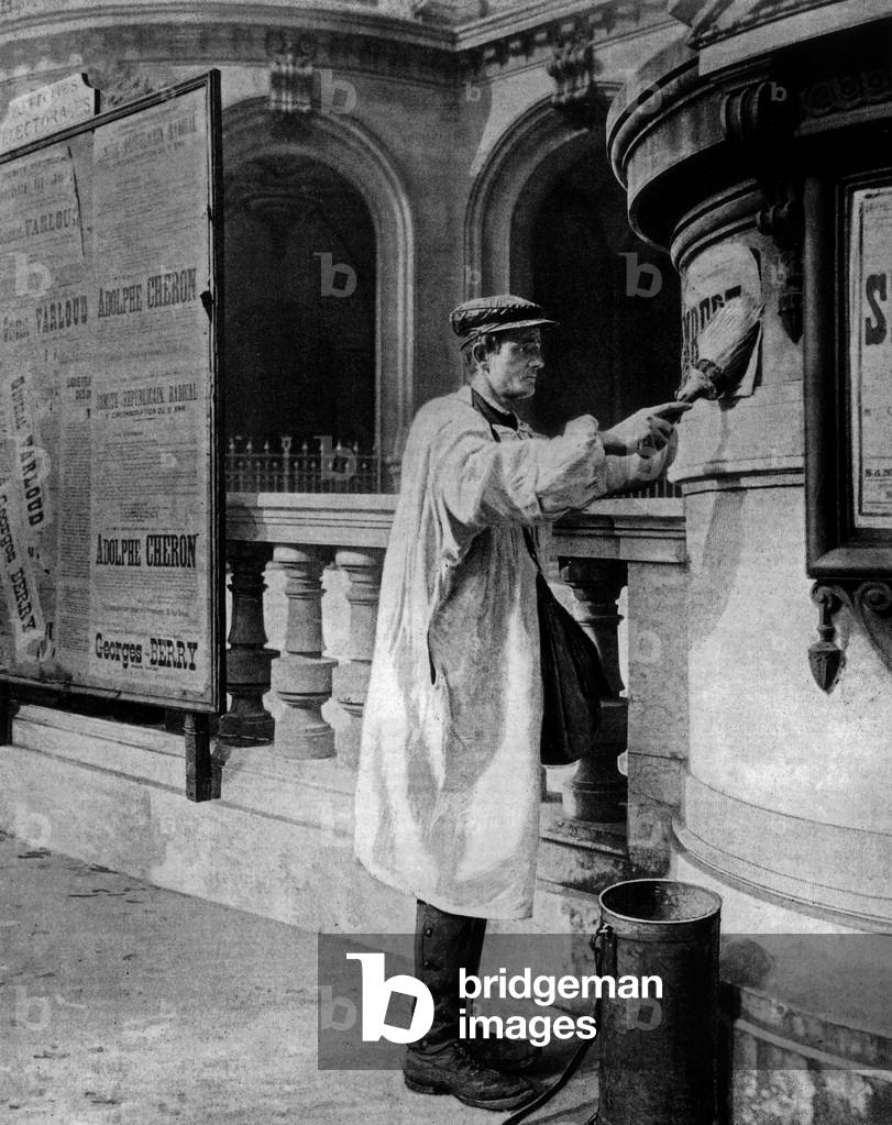 Man sticking electoral posters on the walls of Paris Opera 1902
