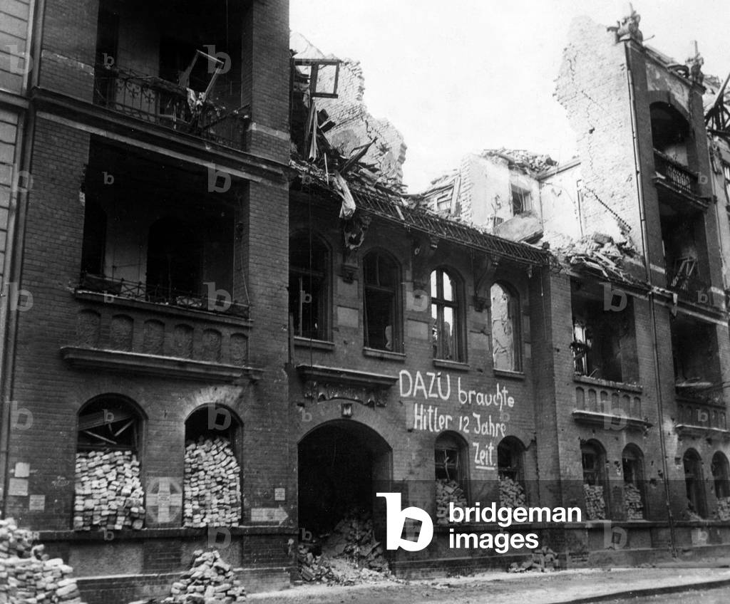 A house in Charlottenburg (berlin) in ruins after bombings, 2nd world war, the graffiti says 