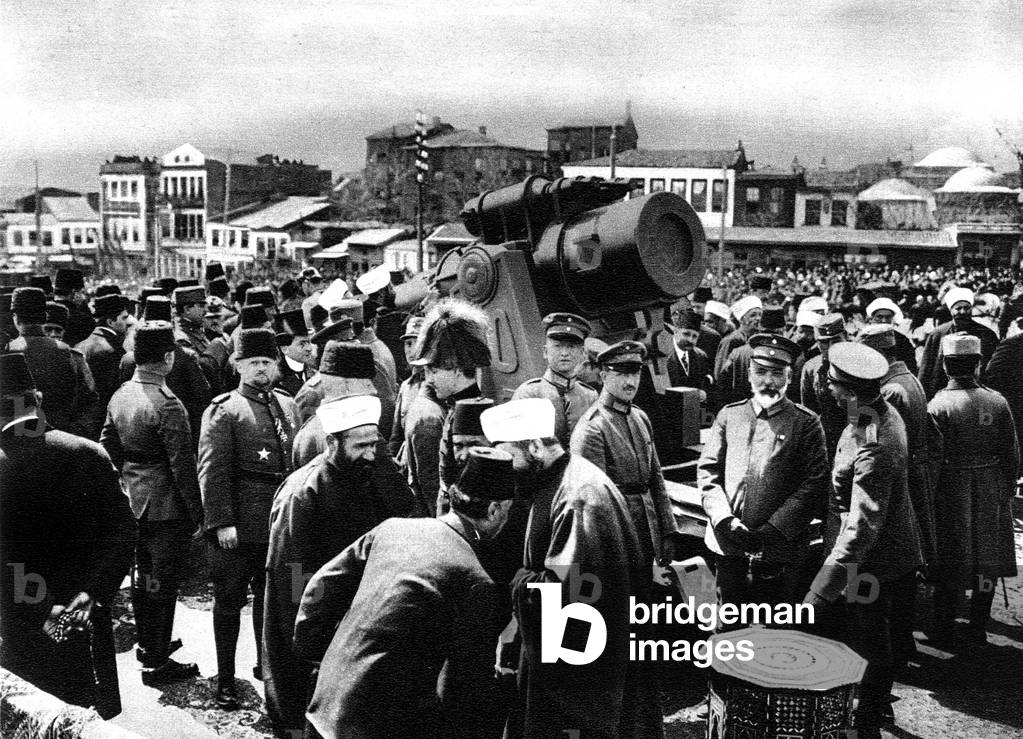 View from Istanbul : turks and their allies driving nails into the Memorial Cannon during launching on the Bajazid Square 1916