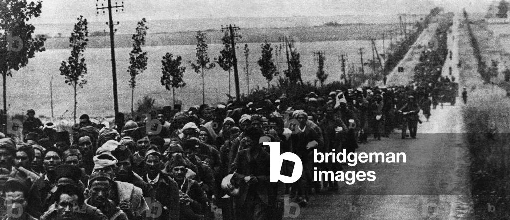 African Armee soldiers taken prisoner, some of whom were wounded, marched on a road in June 1940 during the Great Debacle