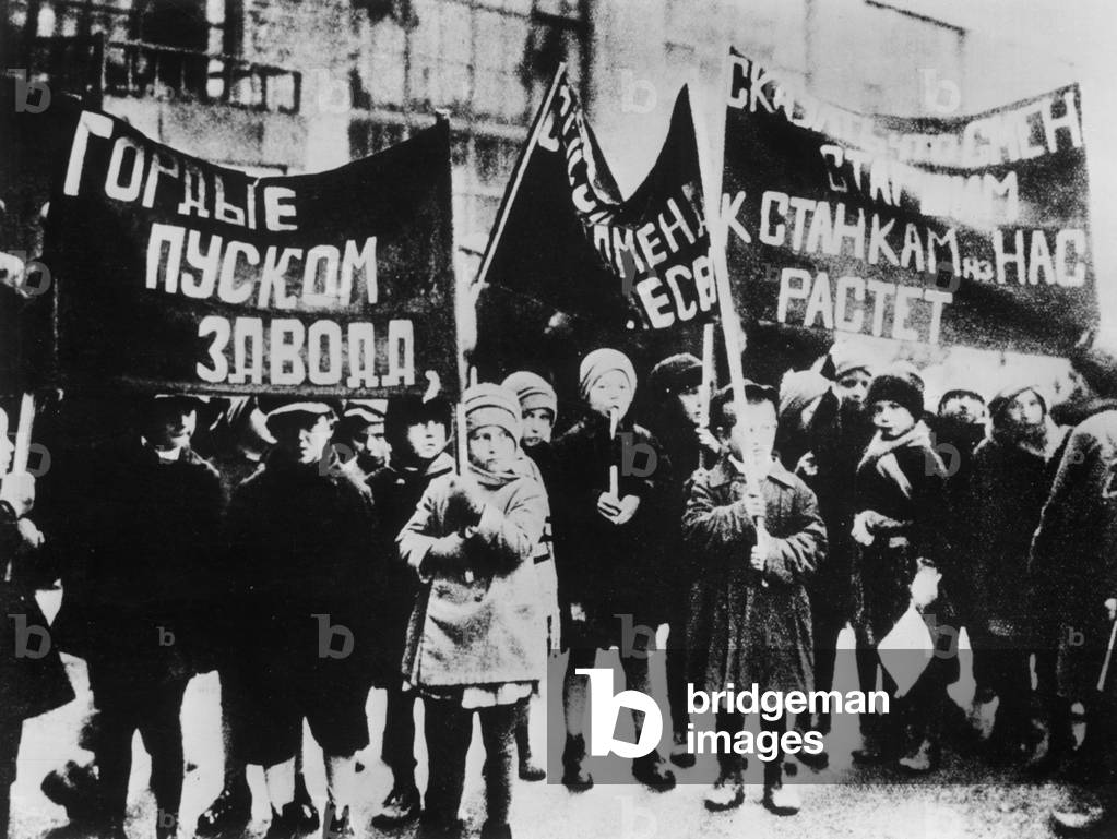 Children of soviet factory workers parading opening of a new plant, 1931 : banners proclaiming their readiness to take their places at the machines when they grow up