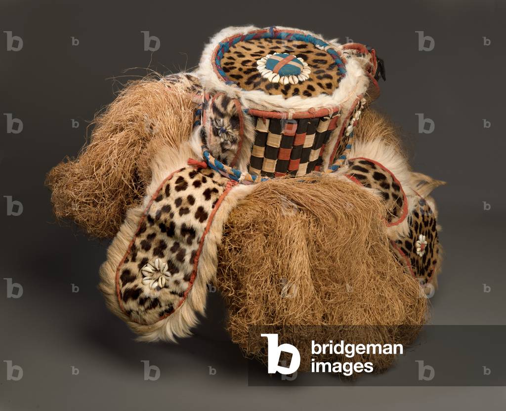 Gbini mask, early 20th century (wood, leopard skin, sheepskin, antelope skin, raffia fibre, cotton cloth, cotton string & cowrie shells)

