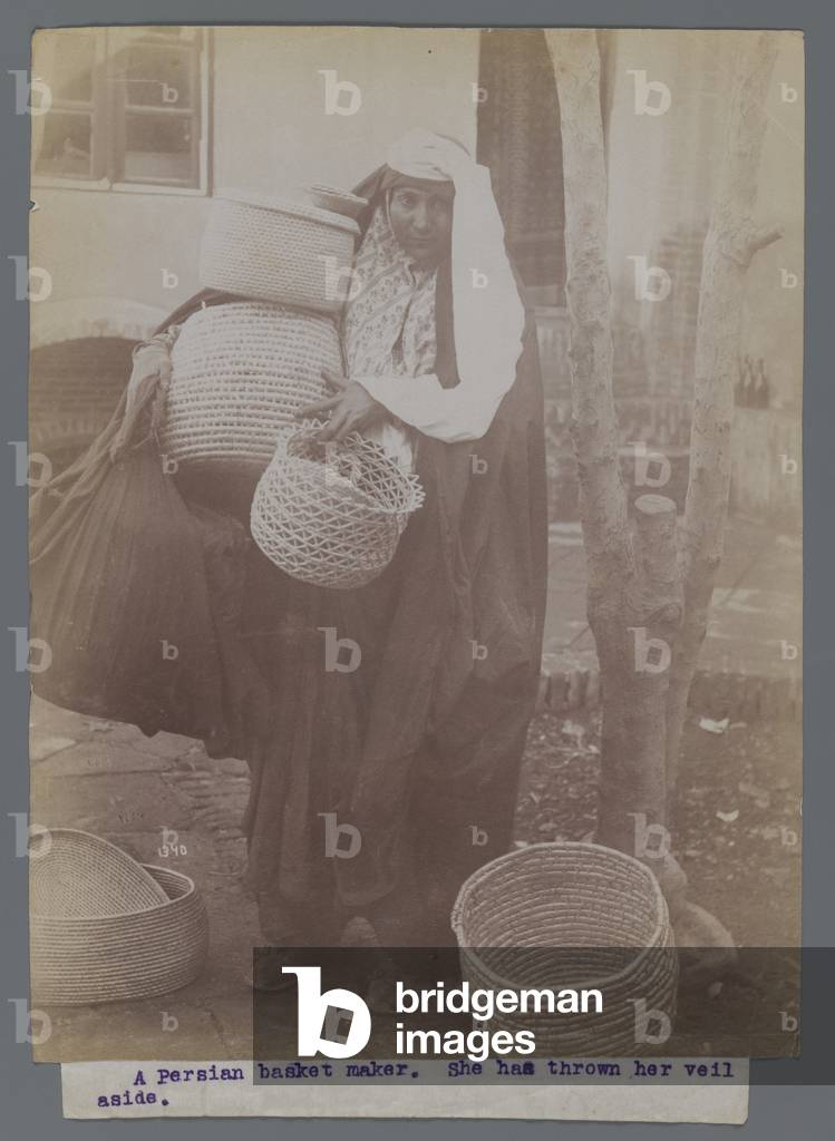 Woman carrying baskets with veil thrown aside (silver albumen photo)