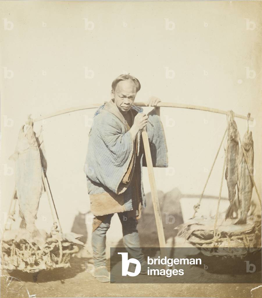 Fisherman with his catch (hand-coloured b/w photo)