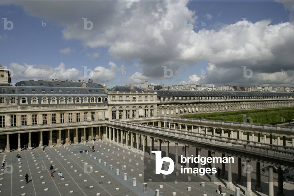 Daniel Buren's columns in the Royal Palace Gardens seen from the Ministry of Culture, rue de Valois in Paris. The columns that grid the court were added in 1986 following a public order from the Ministry of Culture. Photography 19/04/05.
