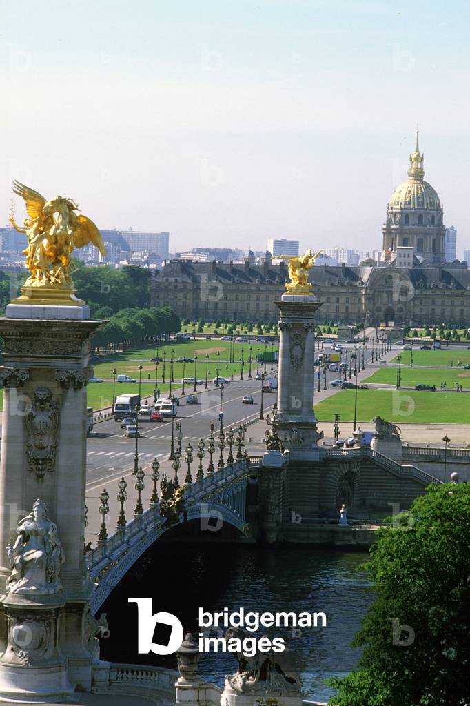 Pont Alexandre III seen from Paris 8th arrondissement. Tsar Alexander III of Russia (1845-1894) laid the first stone of the bridge in 1886, which was to be completed for the 1900 World Expo. One of the most beautiful bridges in Paris has a single-flight metal structure. Ingenieurs Jean Resal and Amedee Alby, architects Cassien Bernard and Gaston Cousin.