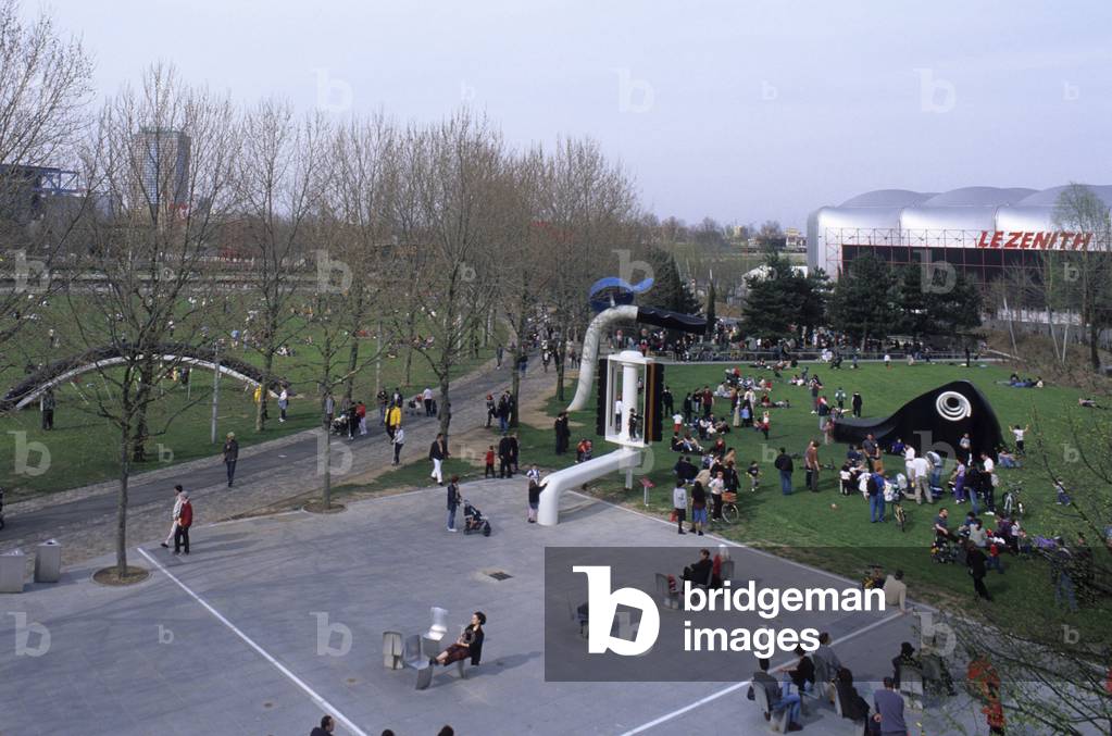 Parc de la Villette, Paris 75019. Architecture by Bernard Tschumi, 1987-1991. This 55-hectare park, divided in two by the Ourcq Canal, is located on the site of the Villette slaughterhouses. The design of the park was entrusted to Bernard Tschumi in 1983. In the background, the Zenith, a venue for rock and variety concerts. One can see the sculpture “” Bicycle buried”” made by Coosje Van Bruggen (1942-2009) and Claes Oldenburg (born 1929) in 1990.