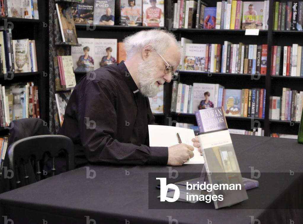 The Right Reverend Rowan Williams signing books at the Cheltenham Literature Festival, 2014. (photo)