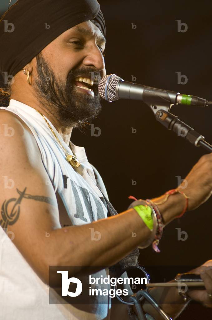 Johnny Kalsi, London-based master drummer of the Dhol Foundation performing at the Wychwood Festival, UK, 31 May 2009.