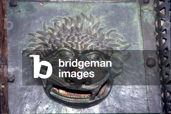 Grotesque face, detail from a portal, Romanesque (bronze)