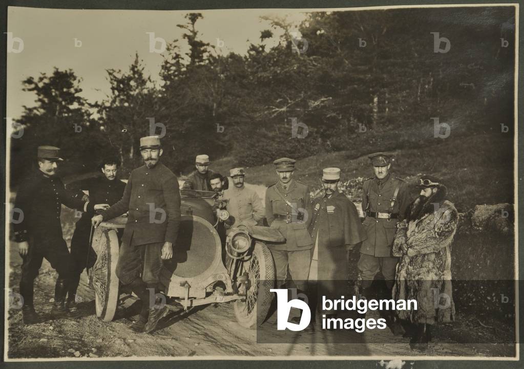 William Lawrence Bragg and Harold Roper as part of a group with a motorcar on a mountain road, Vosges, 1915 (b/w photo)