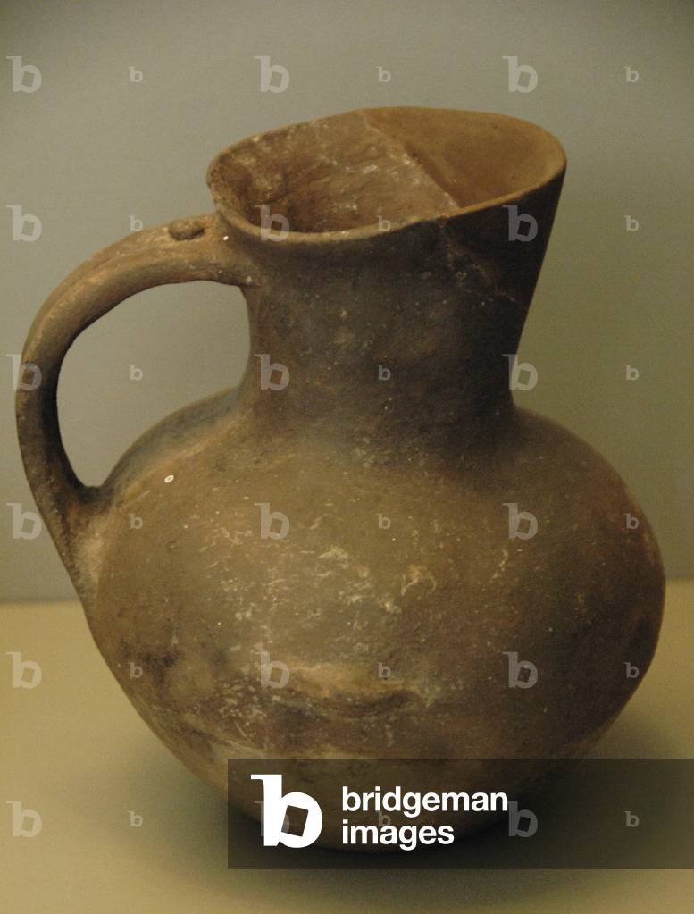Prehistoric Art. Early Bronze Age. Handmade Jar of clay without decoration. Globular body, wide mouth and a handle.