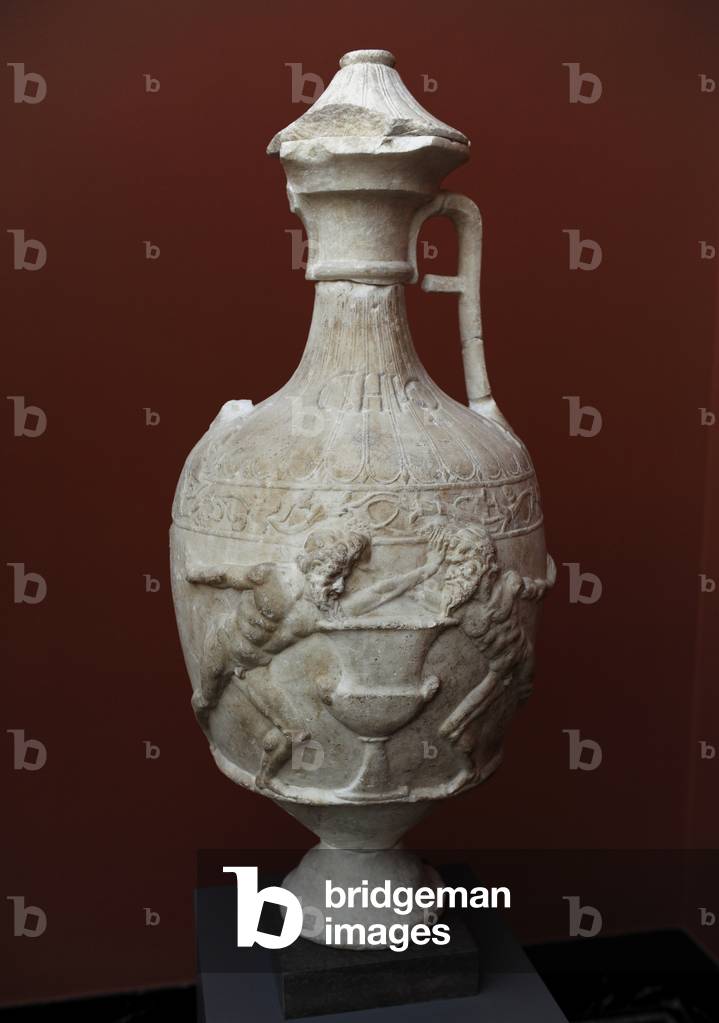 Marble Vase. 1st century B.C.  Decorated with a relief shows two satyrs fighting over a large wine container by pushing each other away. Tha inscription CHIO means that Chio gave the vase. From Sanctuary of Diana at Nemi. Carlsberg Glyptotek Museum. Copenhagen. Denmark.