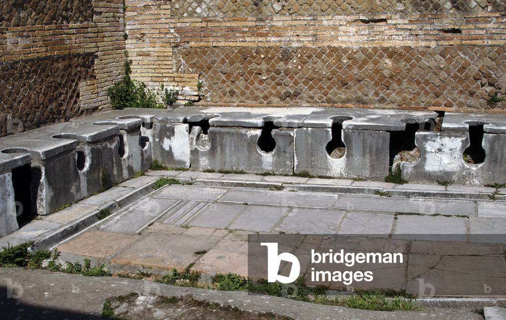Ostia Antica. Latrine at the Domus of Triclini, headquarters of the guild of builders. 2nd century AD. Near Rome.