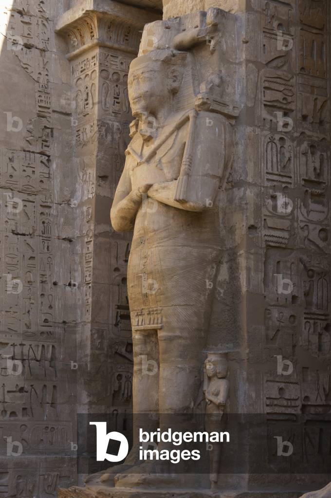 Temple of Ramses III. Great colossal statues of Ramses III deified as Osiris, attached to pillars. Egypt.