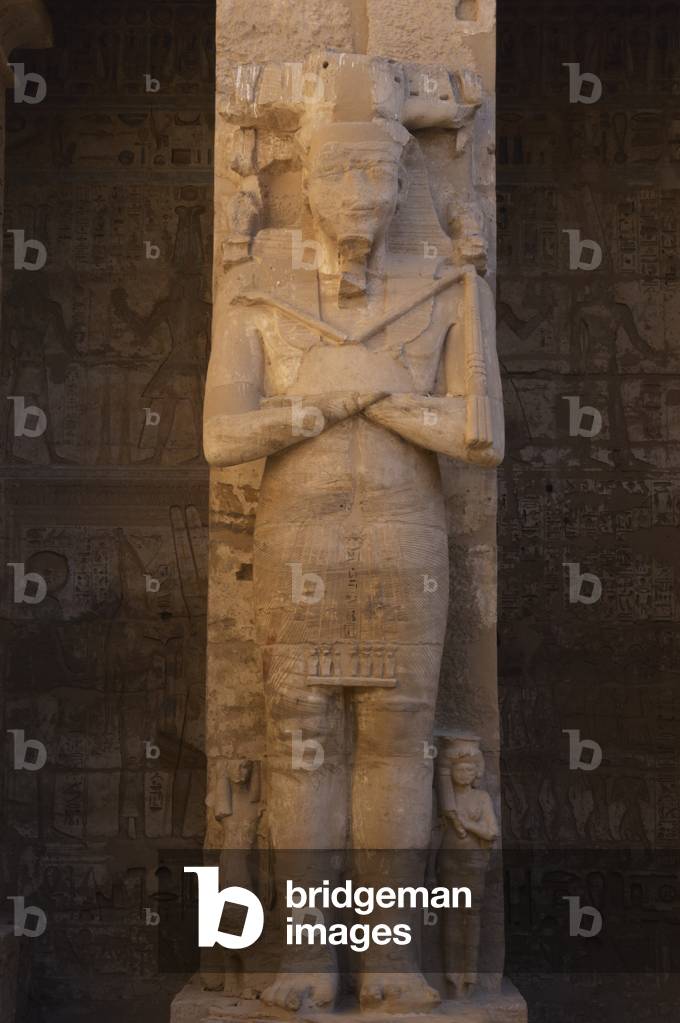 Temple of Ramses III. Great colossal statues of Ramses III deified as Osiris, attached to pillars. Egypt.