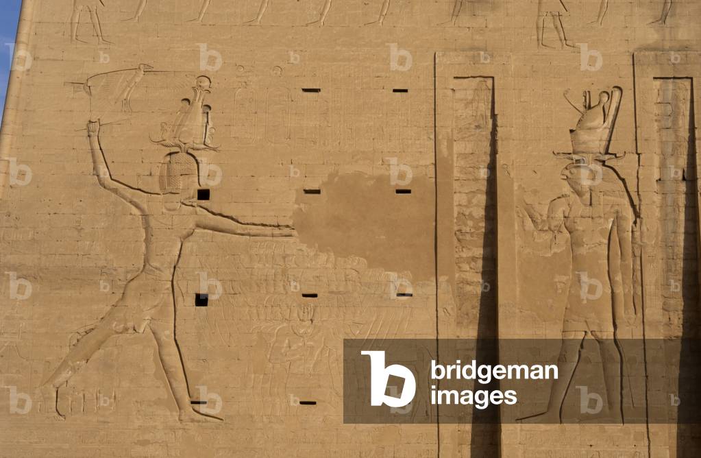 The pharaoh Ptolemy XII Neo Dionysos sacrificing prisoners to the god Horus. Edfu. Egypt.