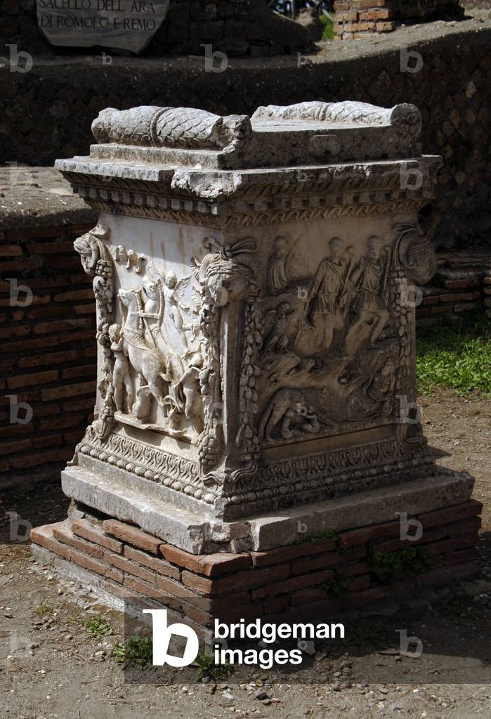 Ostia Antica. Sacellum. Altar of the Twins. Reliefs depicting Cupid carrying the chariot of Mars (left) and Romulus and Remus suckled by the she-wolf discovered by shepherds (right). Italy.