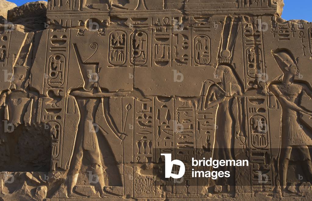 Egyptian Art. Karnak. A pharaoh before a god. Relief.