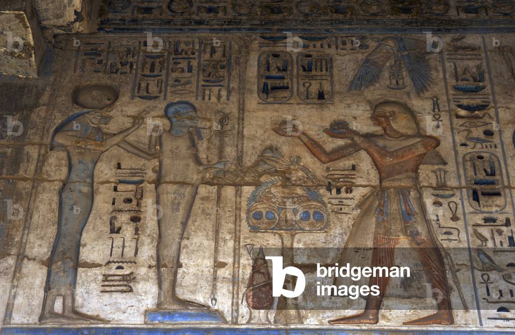 Temple of Ramses III. The pharaoh making offerings before goddess Tefnut and god Ptah. Relief. Egypt.