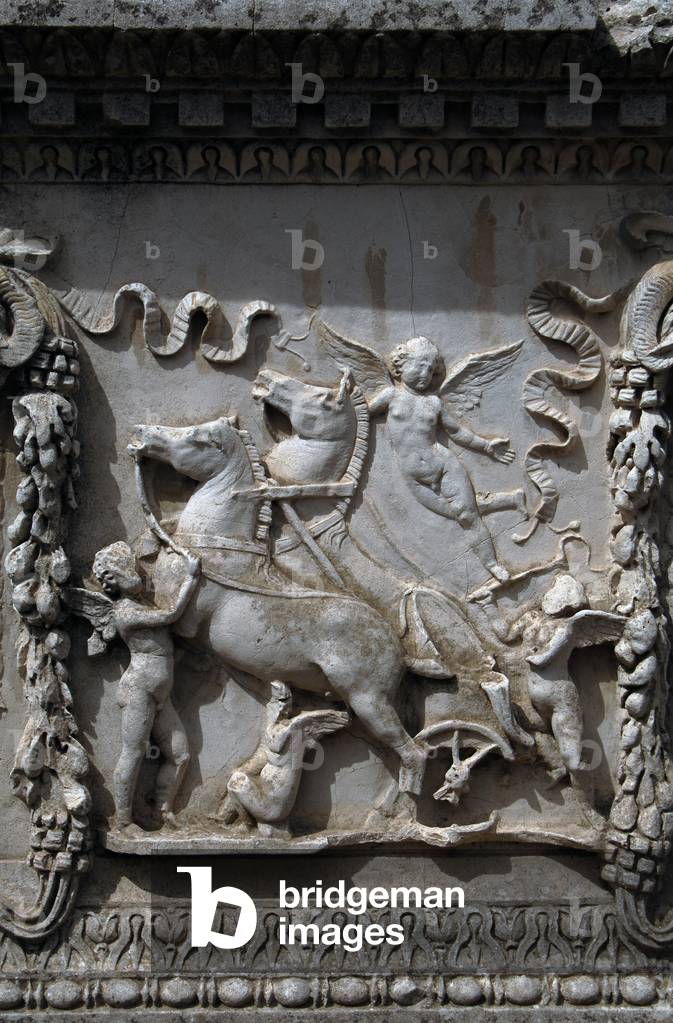Ostia Antica. Sacellum. Altar of the Twins. Relief depicting Cupid carrying the chariot of Mars. Italy.
