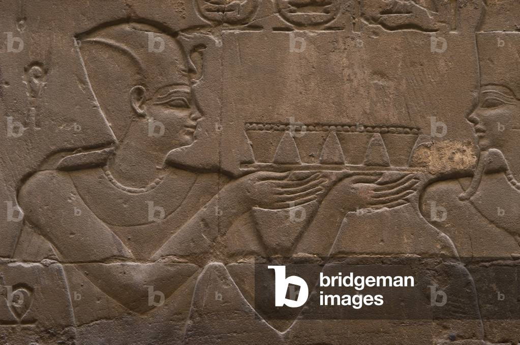 Relief depicting a pharaoh making offerings to the god MIN.
