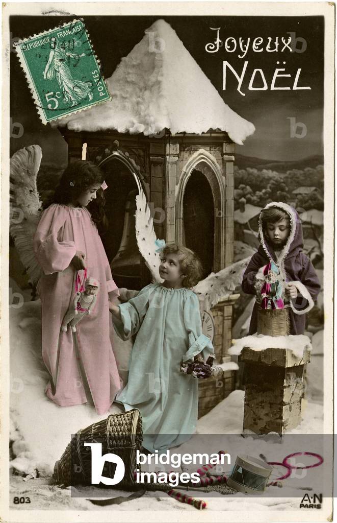 Postcard, Christmas greetings: Angels in the snow with a hood and toys. Begin the 20th century.
