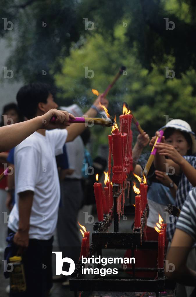 Religious worship in China: devotions in front of a temple.