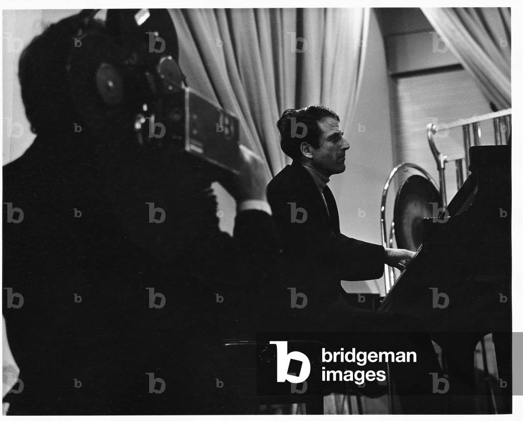 Lukas Foss, composer and conductor, seated at piano at Second Festival of the Arts, March 1968