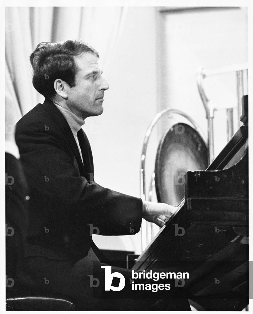 Lukas Foss, composer and conductor, seated at piano at Second Festival of the Arts, March 1968