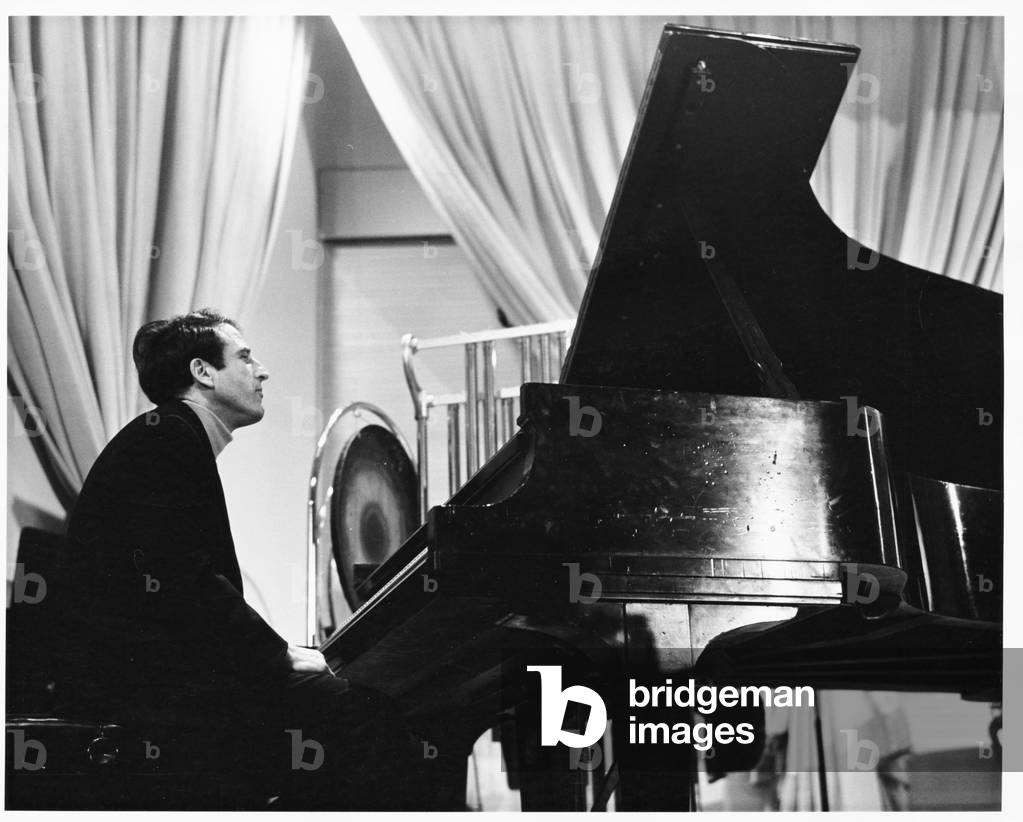 Lukas Foss, composer and conductor, seated at piano at Second Festival of the Arts, March 1968