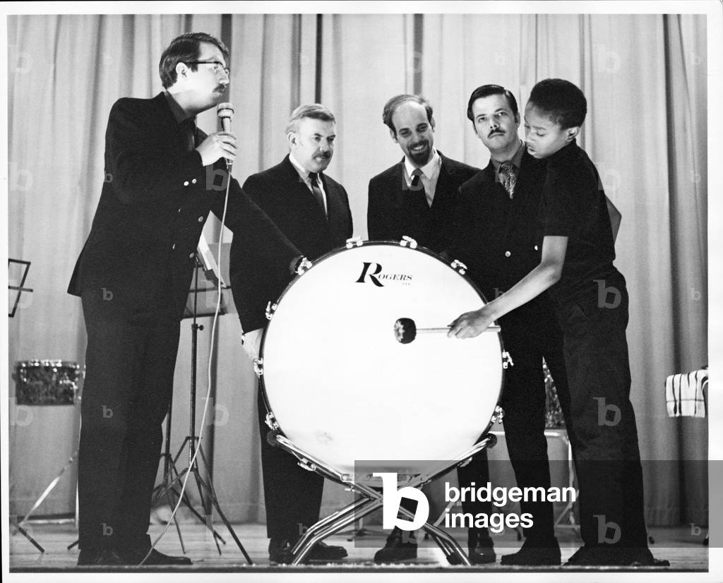 New Percussion Quartet performing at a grade school with student playing bass drum , 1968