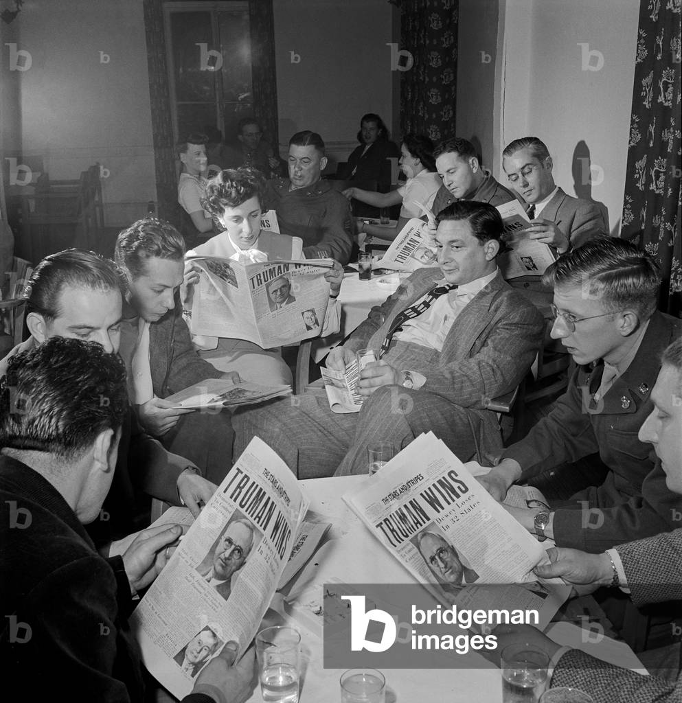 Truman Wins: Reading the news at Truman had won the election, Darmstadt, Germany, 1948 (b/w photo)