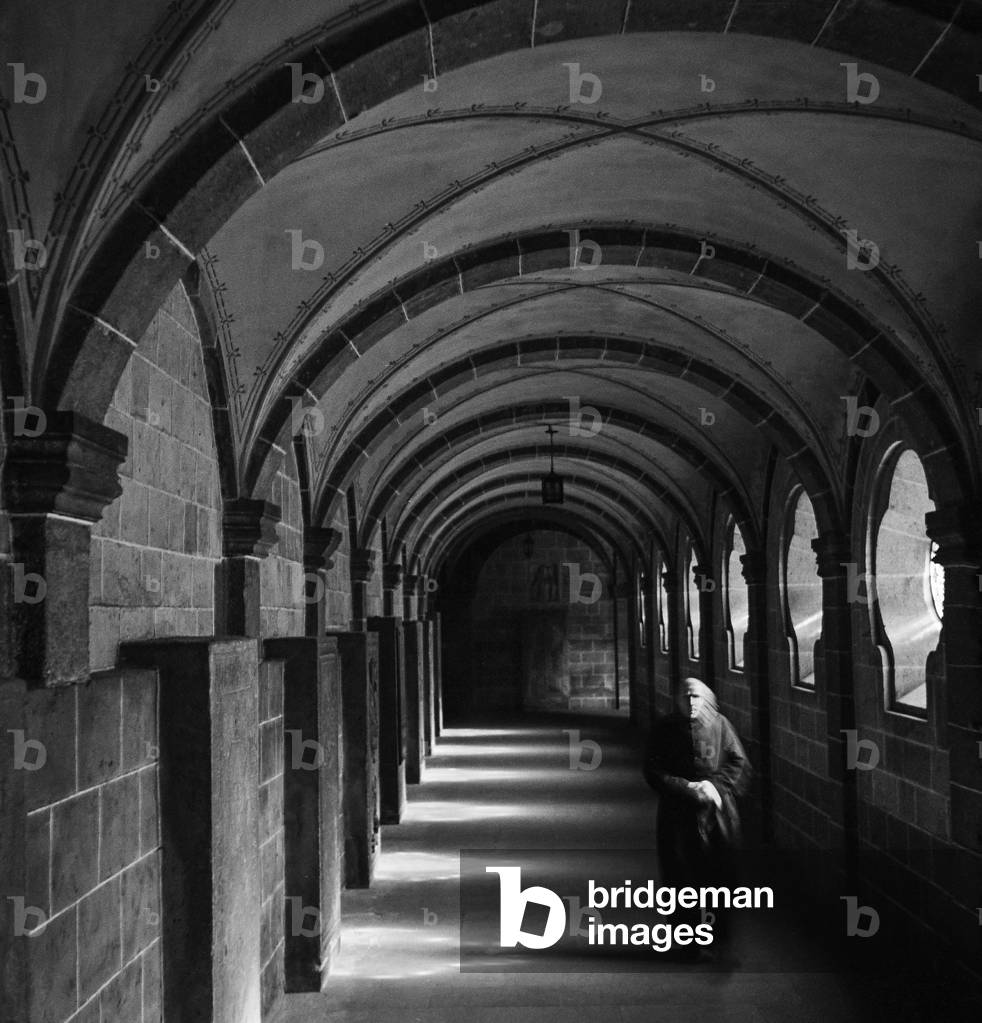 Walking the halls at Maria Laach Abbey, Glees, Germany, 1947-49 (b/w photo)