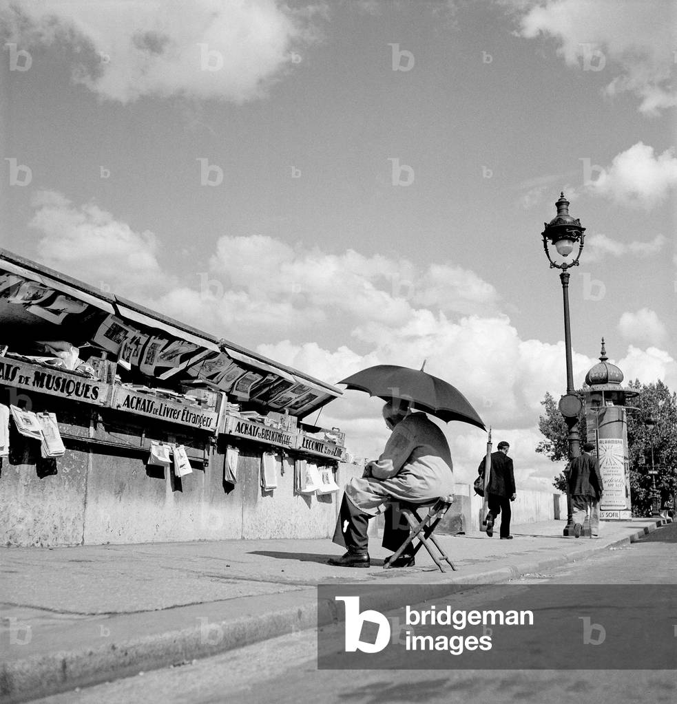 Magazine stand along the Seine river in Paris (b/w photo)