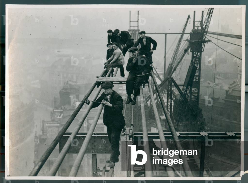 Workers precariously perched high up on the emerging Tyne Bridge in 1927 (b/w photo)