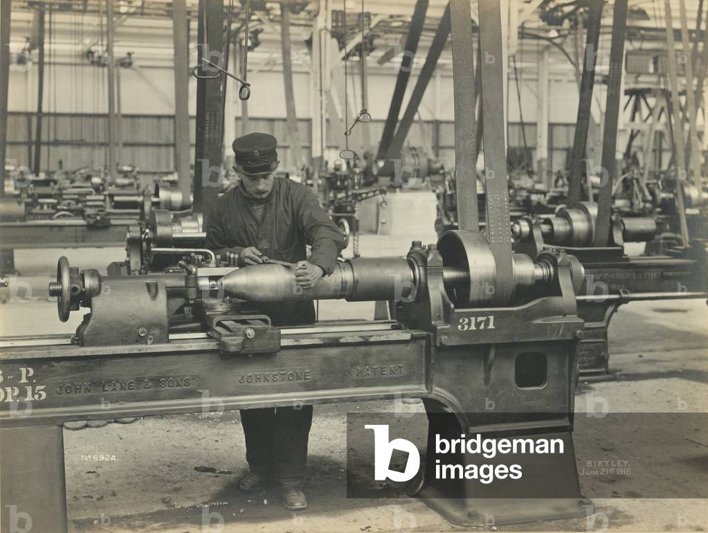Filing weight off radius and cleaning outside of the shell at the National Projectile Factory, Birtley, UK, 21 June 1916 (b/w photo)