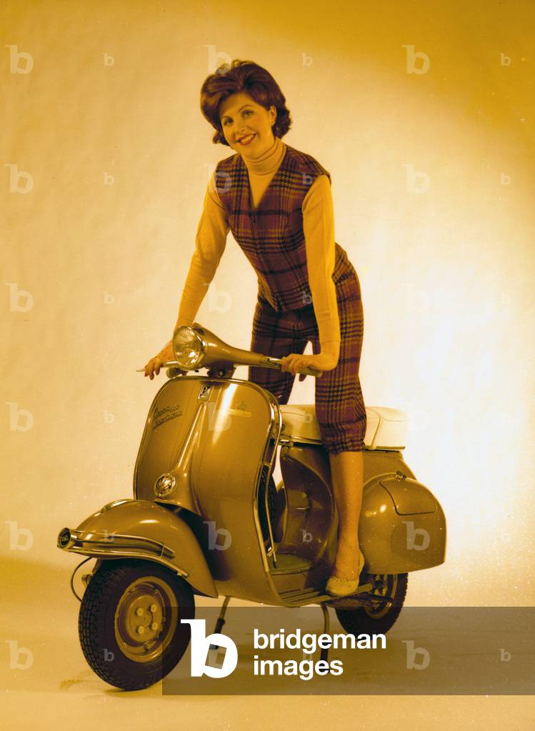 Model posing an a motor scooter: 