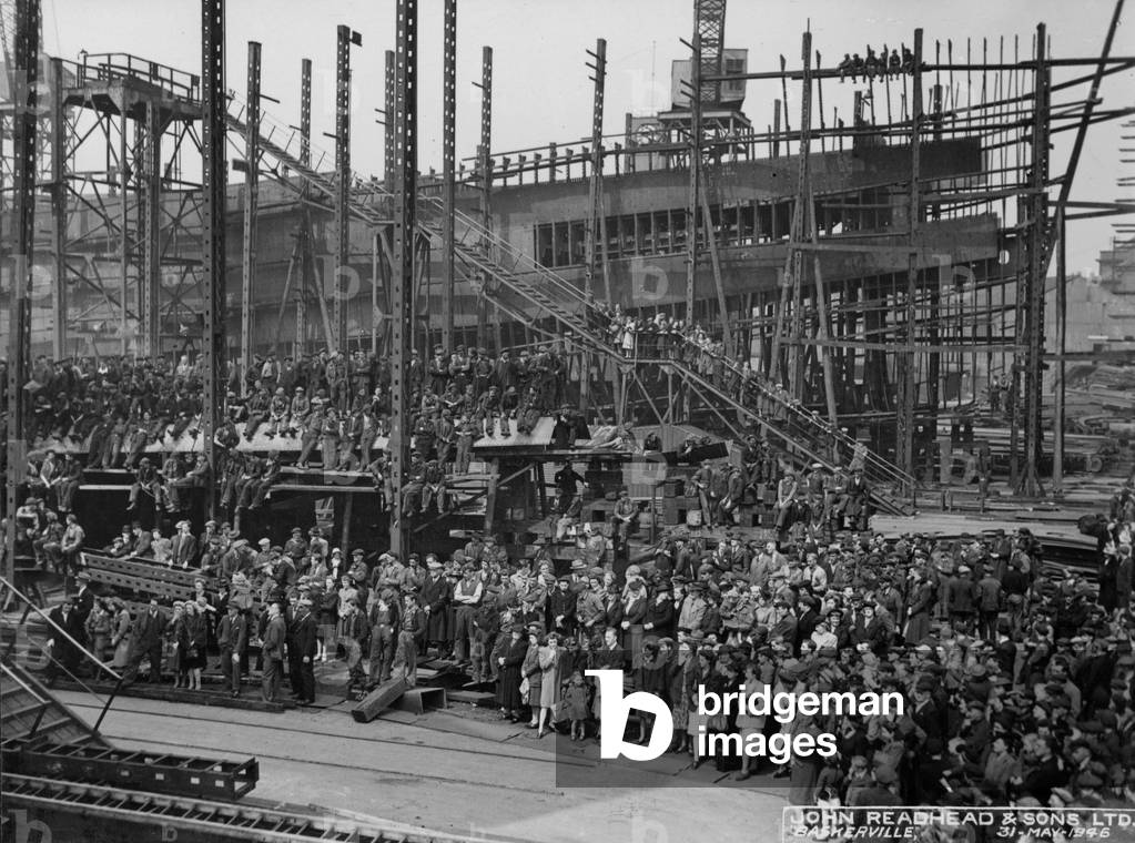 Spectators and workers at the launch of the cargo ship 'Baskerville', South Shields, UK, 1946 (b/w photo)