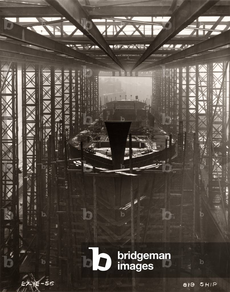 Work is ongoing around the bow of the cargo ship 'Northbank' at the shipyard of William Doxford & Sons, Sunderland, 27th December 1956 (b/w photo)