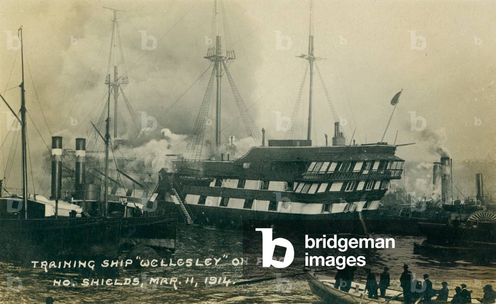 Postcard of the Training Ship 'Wellesley' on fire at North Shields, UK, 11 March 1914