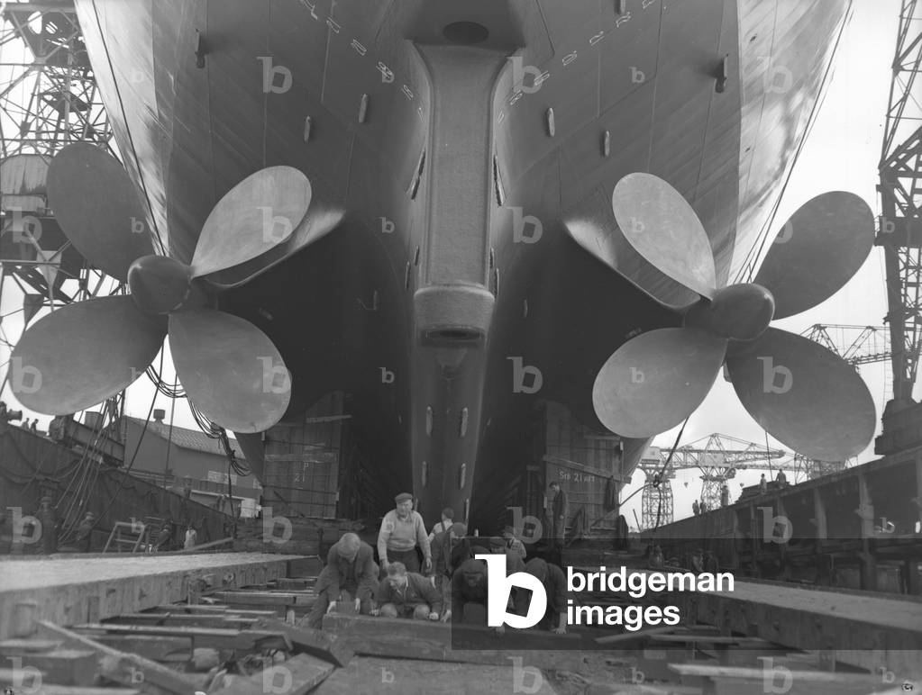 Preparing the slipway for a launch, Newcastle, UK, 1961 (b/w photo)

