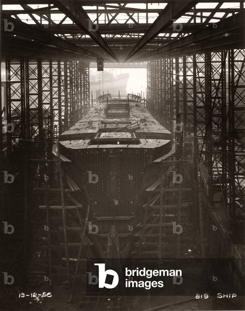 Gantry crane in operation above the cargo ship ‘Northbank’ at the shipyard of William Doxford & Sons, Sunderland, 13th December 1956 (b/w photo)