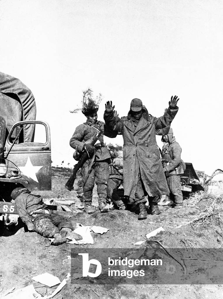 Survivors of an American military unit surrendering to Chinese People's Volunteers, Korean War, January 1951 (b/w photo)
