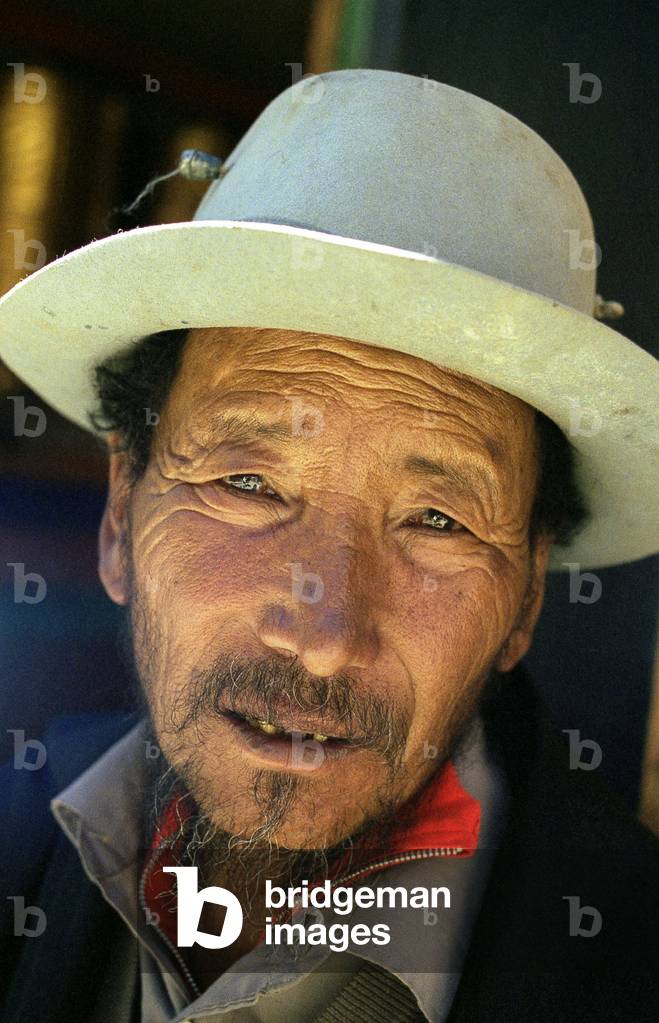 Portrait of a Tibetan man wearing a traditional hat, Lhasa, Tibet, China, August 2004
