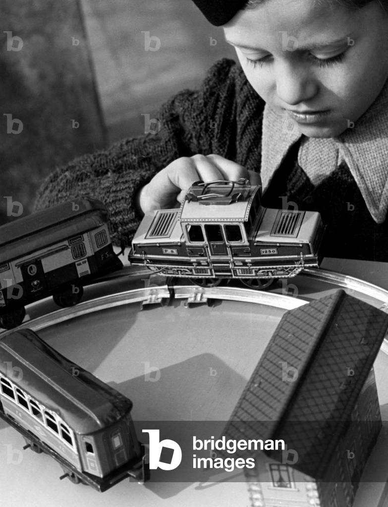 Little Boy Playing With Miniature Train, November 1949 (b/w photo)