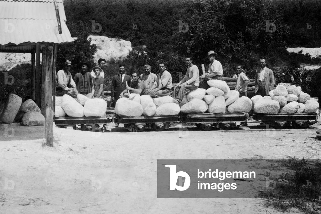 Italy, Tuscany, Castellina Marittima, workers in front of the alabaster warehouse, 1920 (b/w photo)