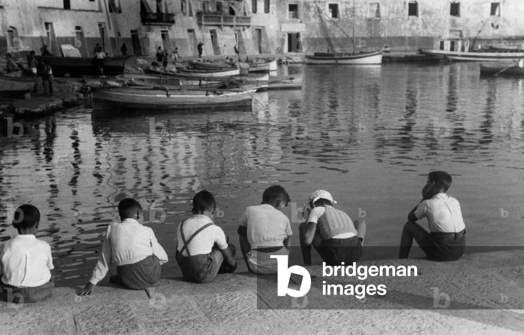 Tuscany, Portoferraio, Children Sitting on the Edge of the Pier, 1930 (b/w photo)